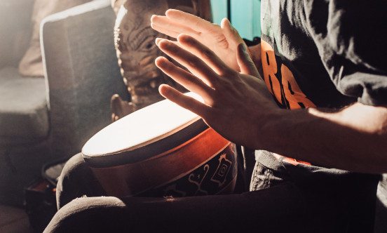 A hand beating on some drums